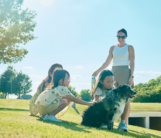 Mother with three children and dog in the park