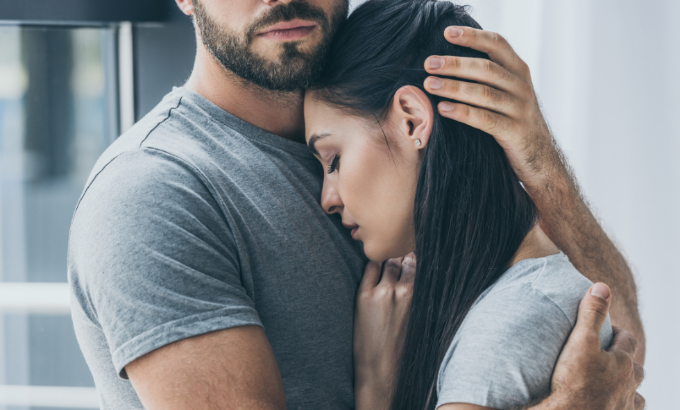 Woman being embraced by a man