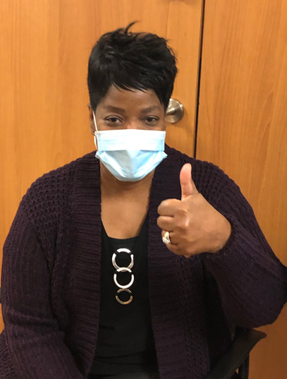 COVID vaccinated CCMH employee posing for picture with a thumbs up