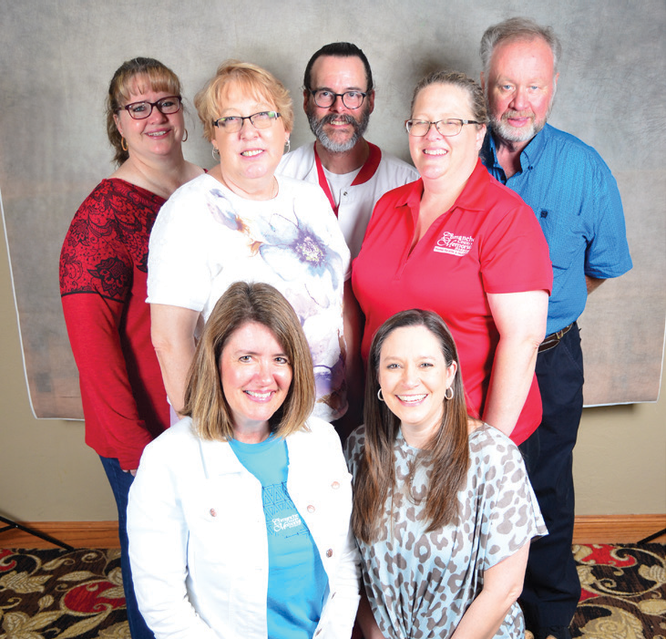 Smiling group of CCMH employees