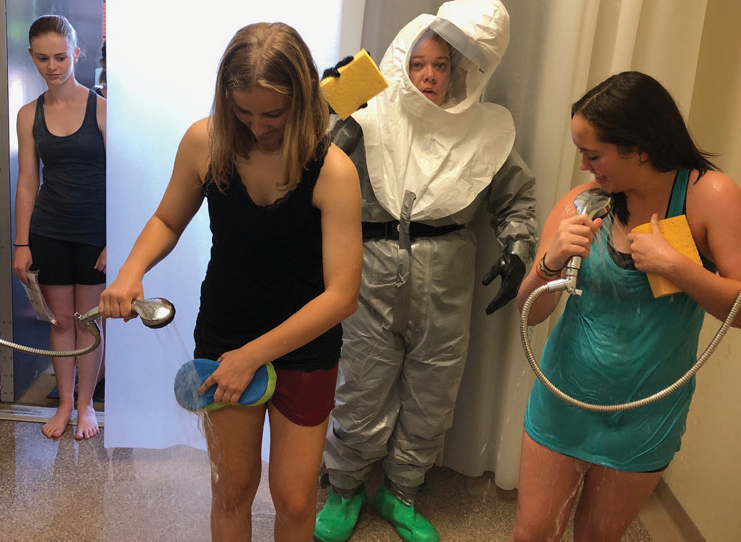 High school girls in hazmat suits demonstration