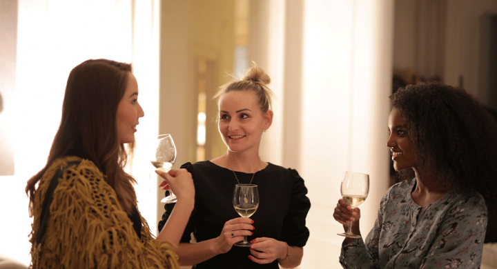 Young ladies drinking wine