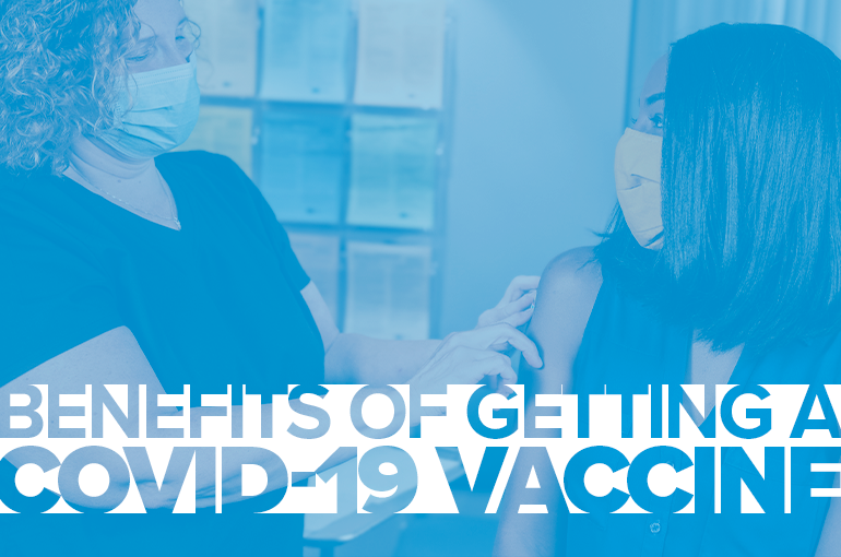 physician putting a bandage on patient who just received COVID vaccine,