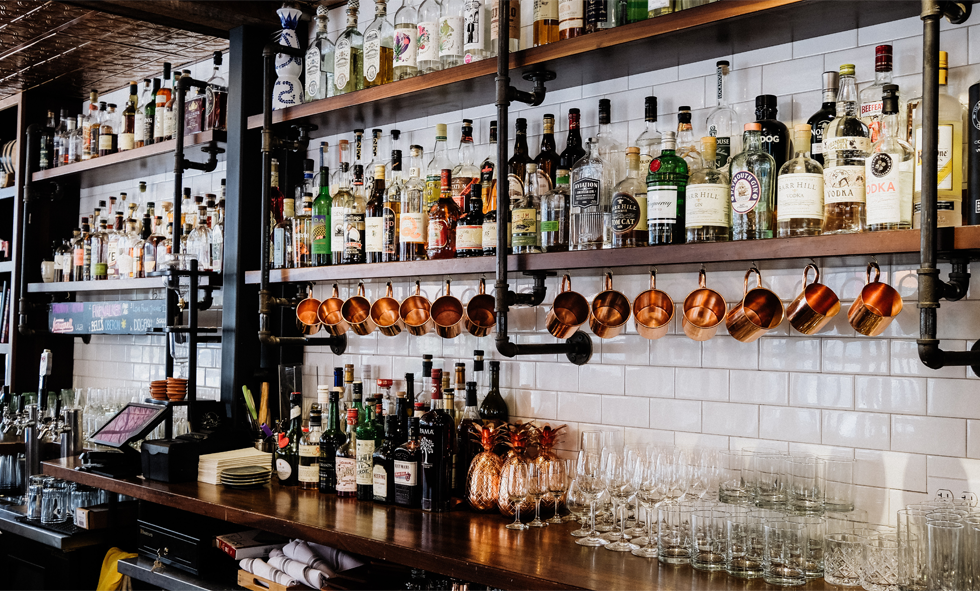 bar shelves full of bottles of alcohol