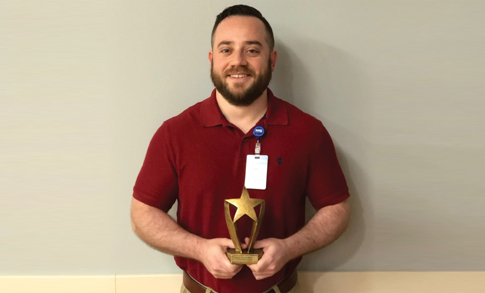 Eric Britten holding Rising Star Award